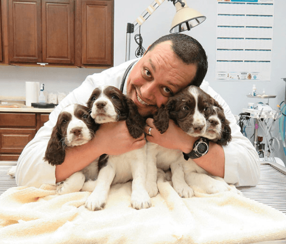 Dr. Samuel Rivera holding puppies